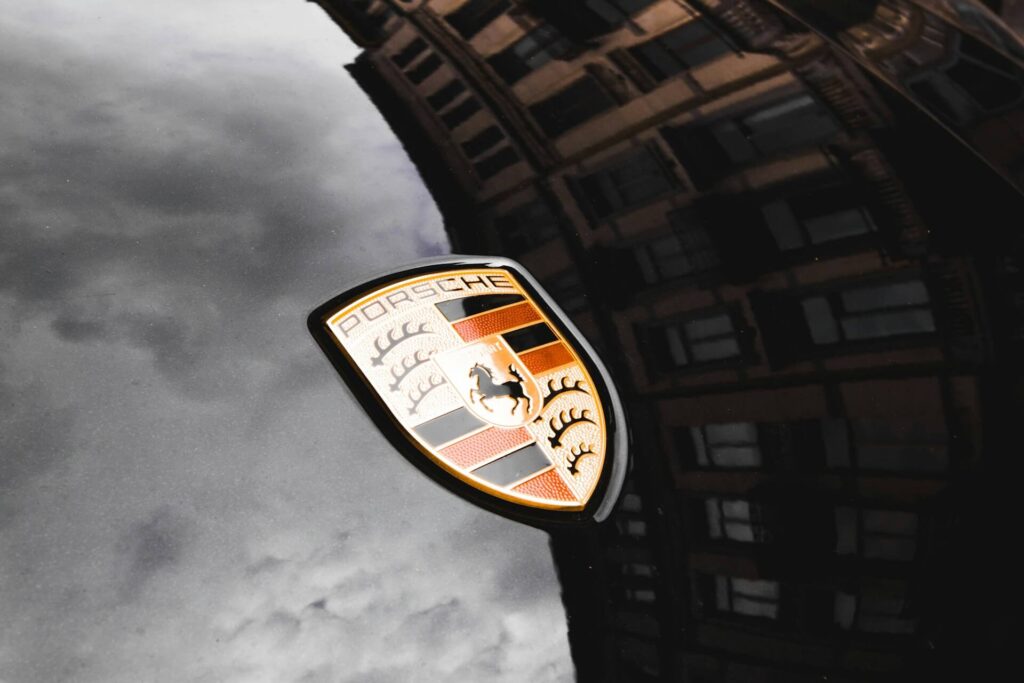 The Porsche logo on a reflective surface