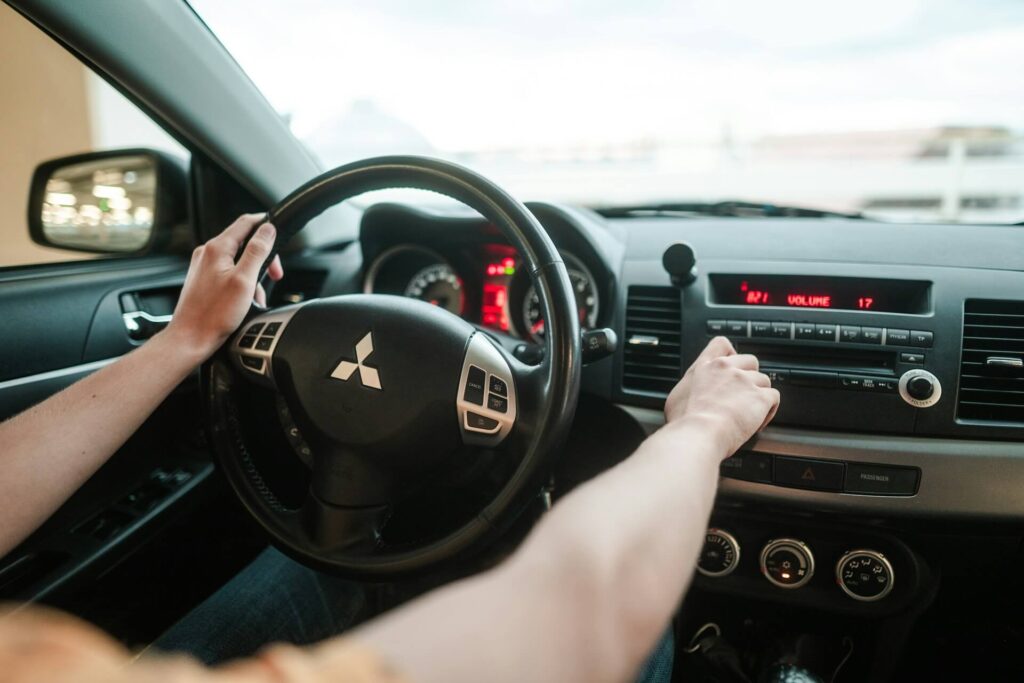 Person driving a Mitsubishi car in the daytime