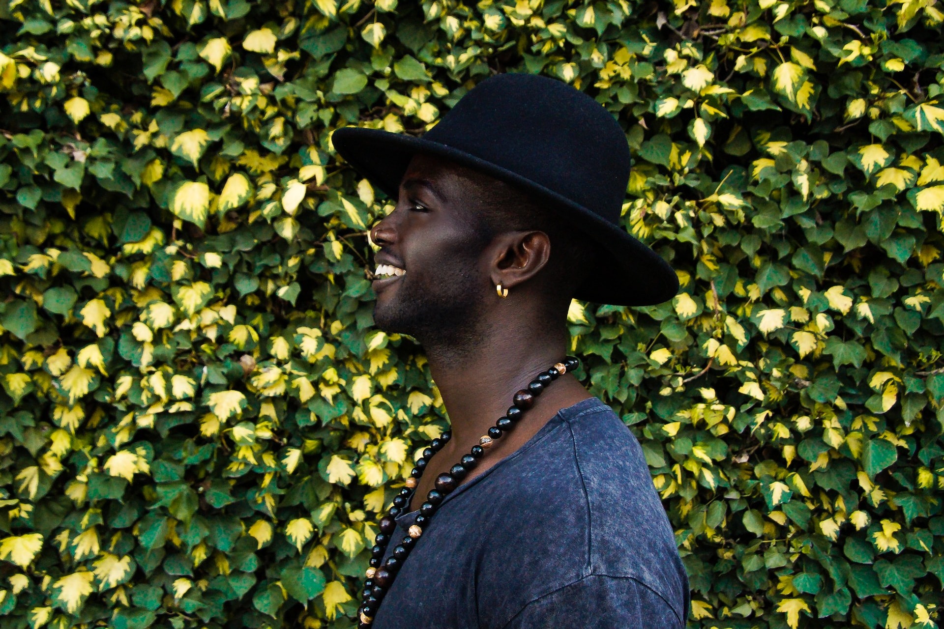 Man wearing hat with earring.