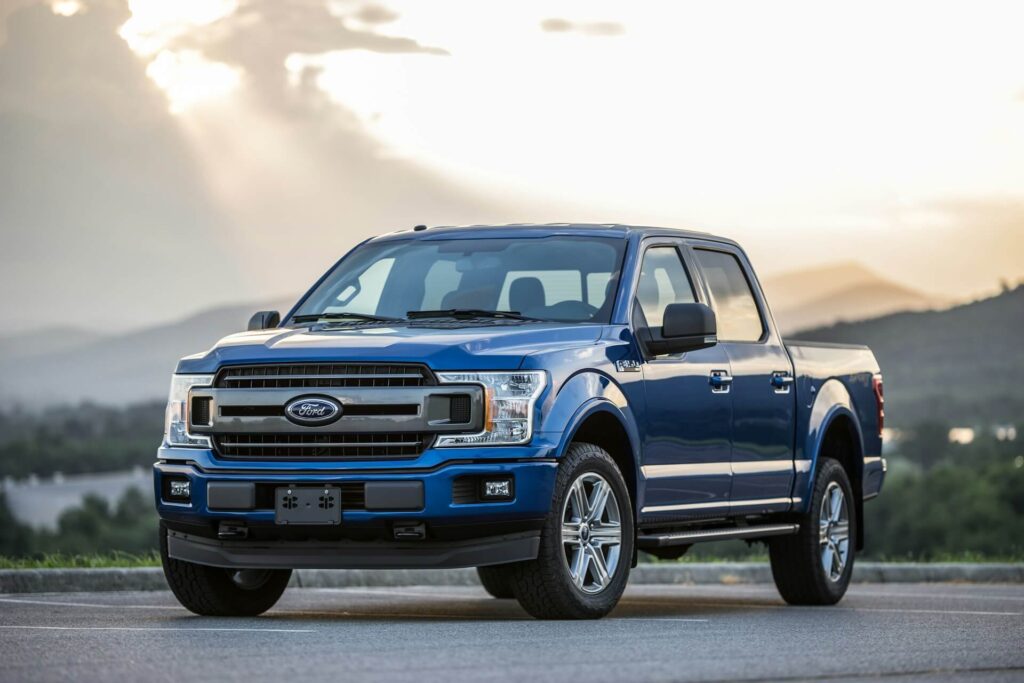 A blue Ford F-150 in a parking lot