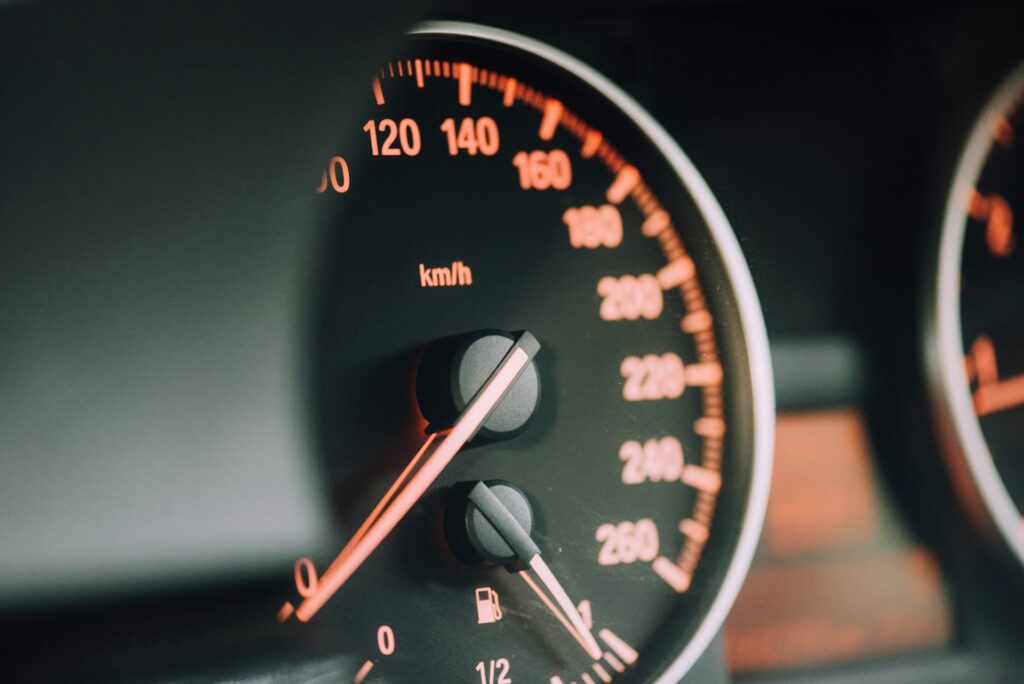 Dashboard speedometer showing a low fuel light