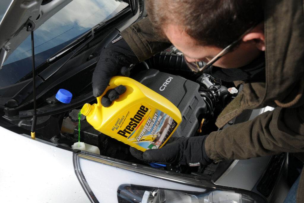 A bottle of coolant being poured