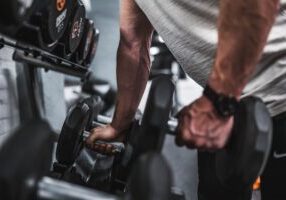 Man lifting up dumbbells.