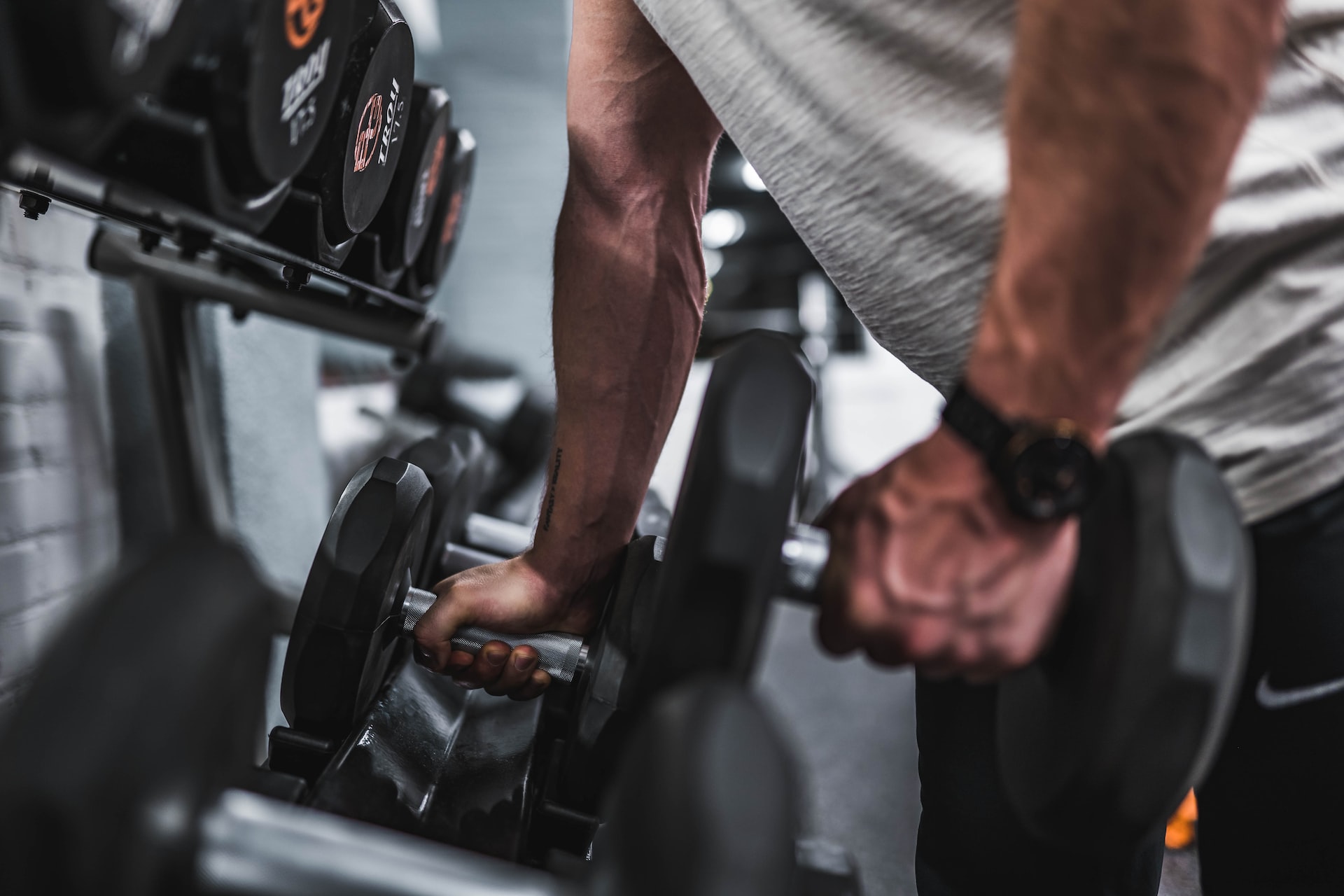 Man lifting up dumbbells.