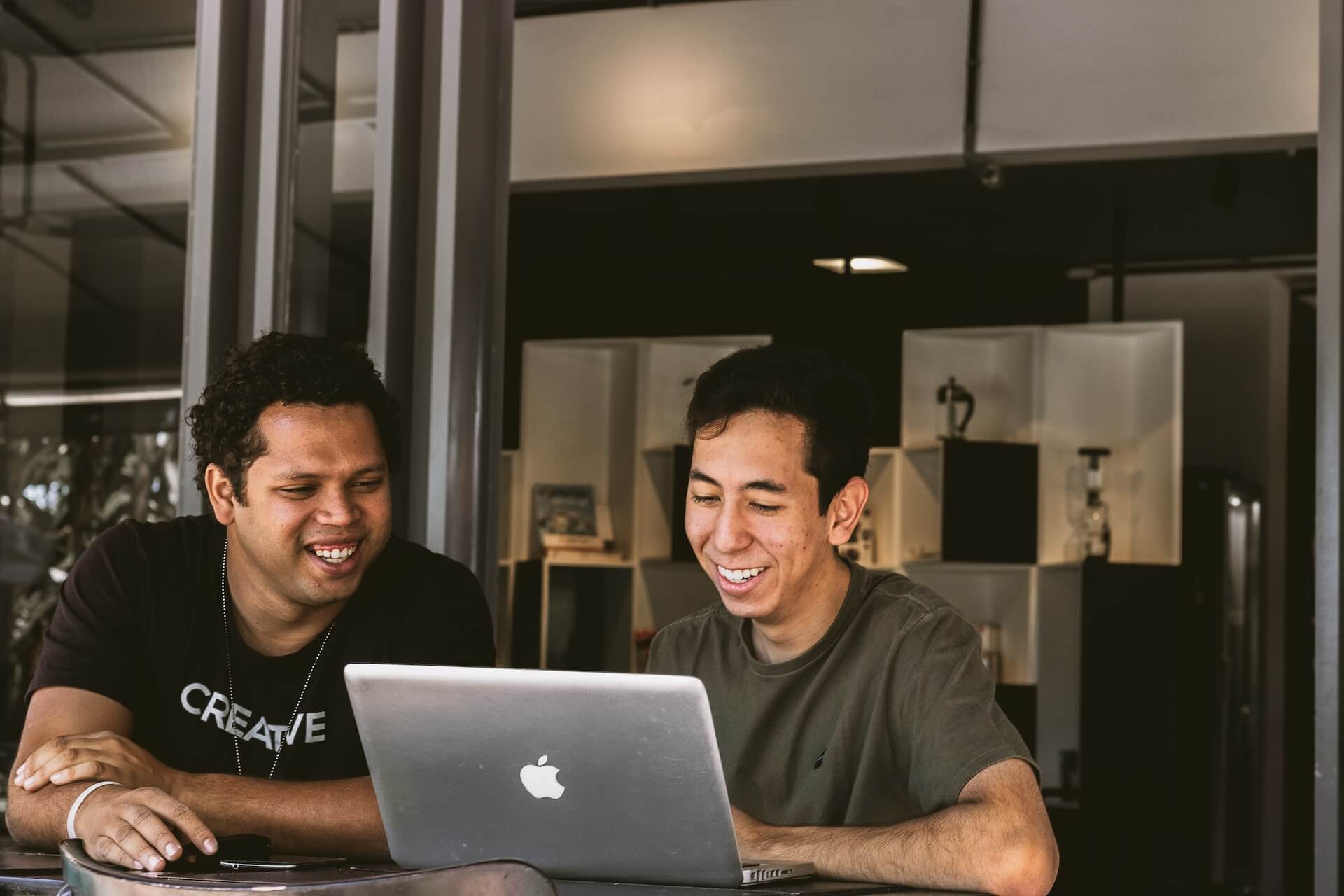 Two men looking at a laptop - AI game