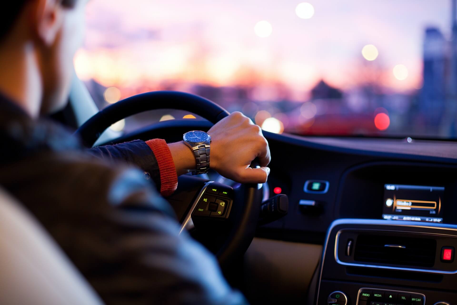 Man behind wheel of a car.