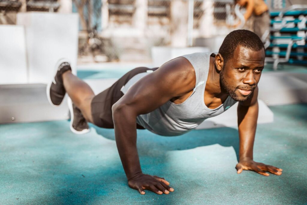 Man doing a pushup with one foot elevated