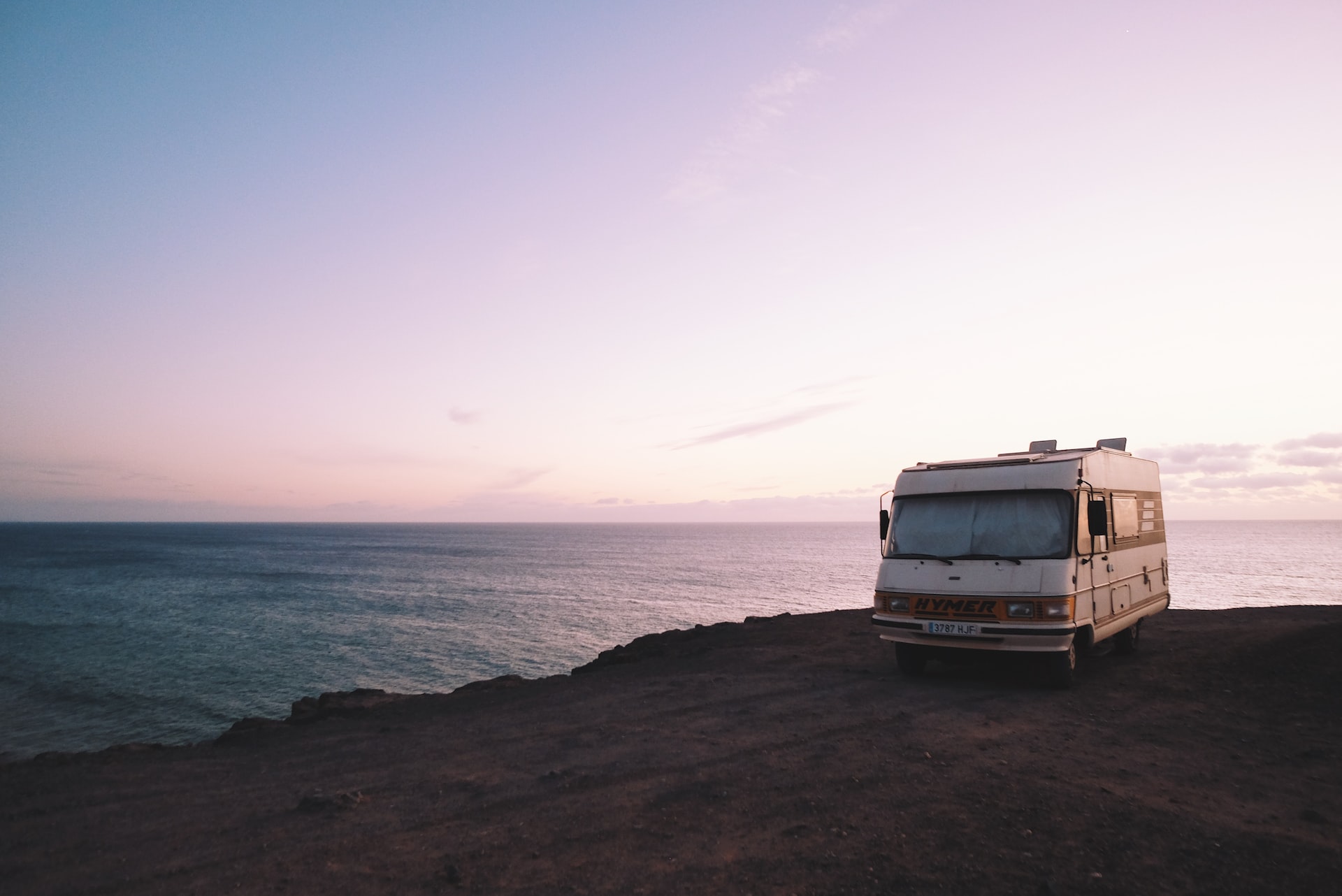 RV on cliff near the water.