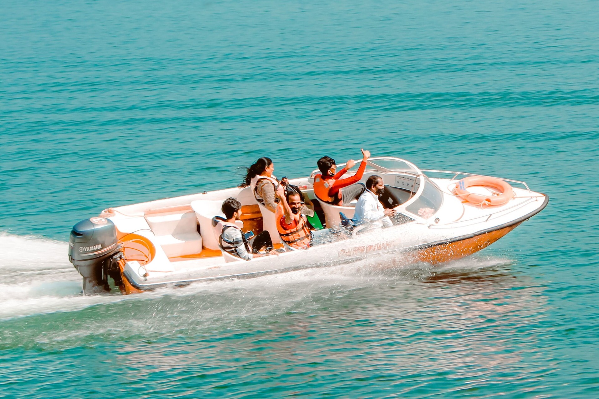 a family riding a speedboat