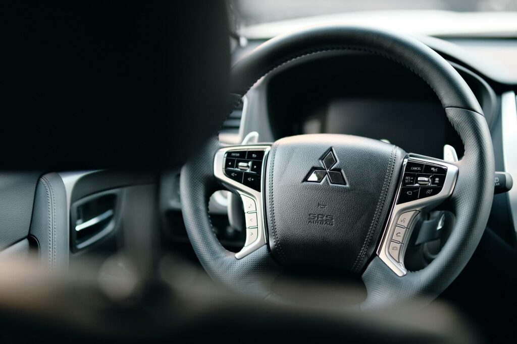 Mitsubishi steering wheel picture taken from the backseat