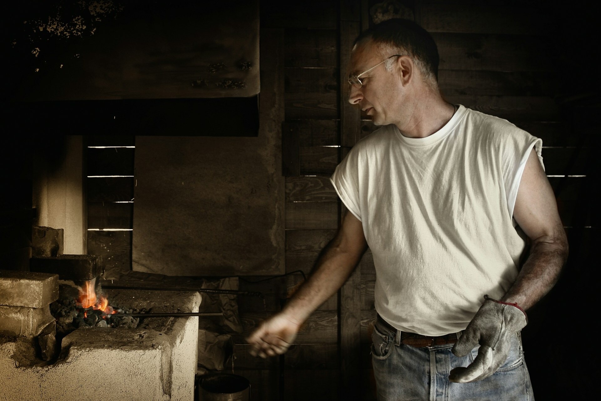 A blacksmith heating metal.