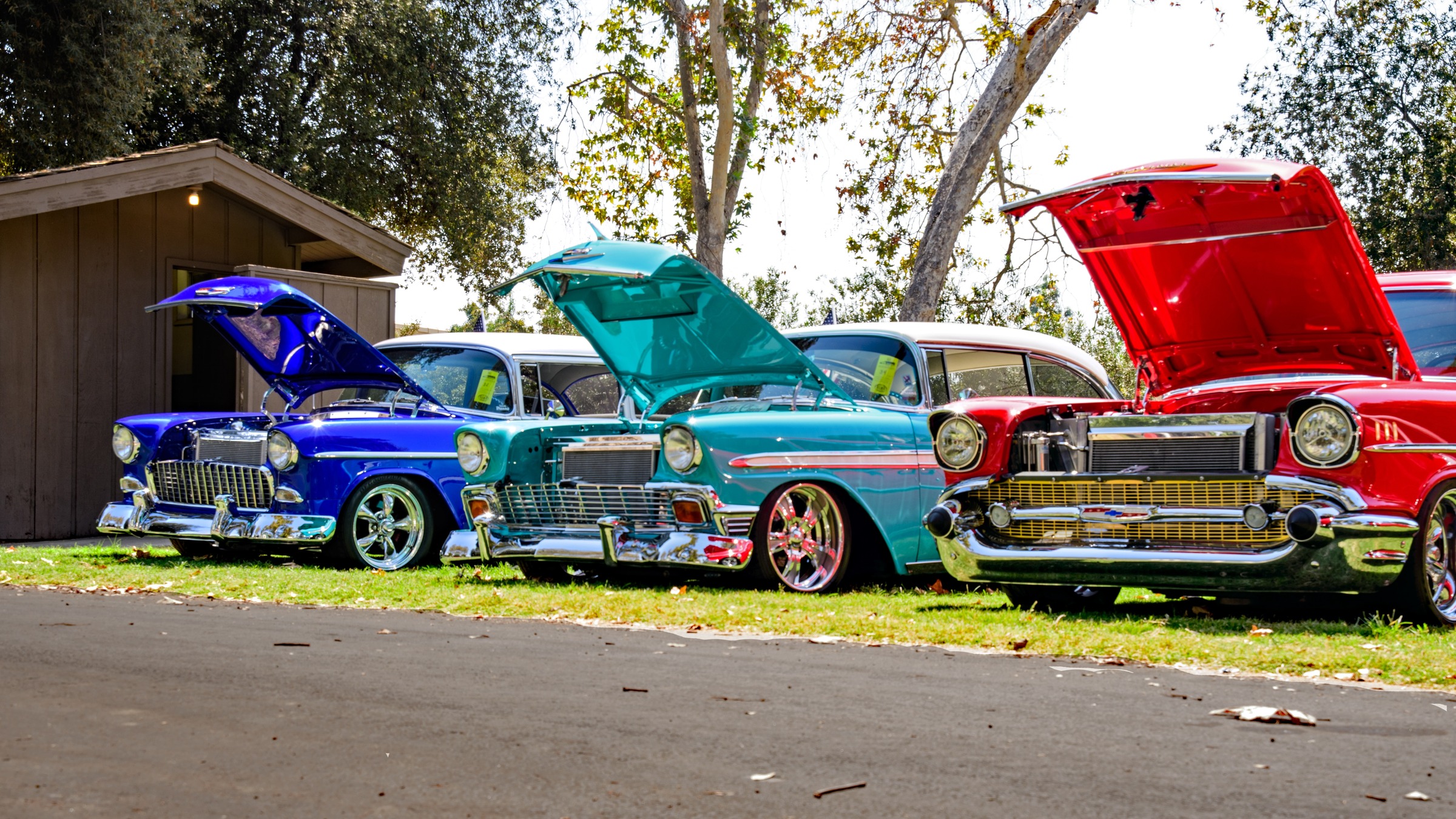 A row of three repaired and restored classic cars