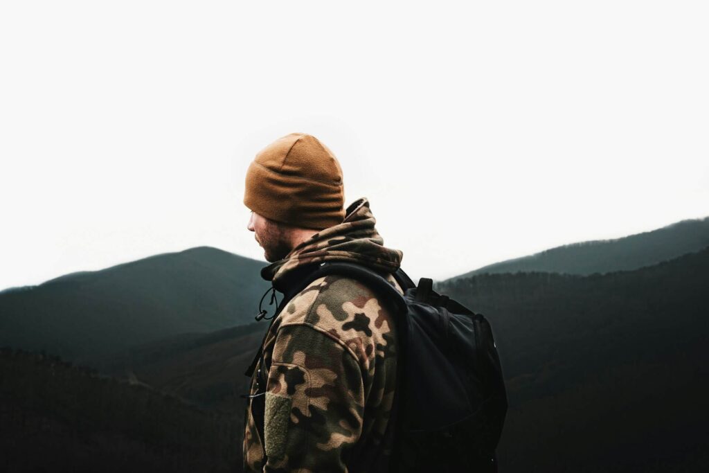 Man with a camouflage jacket and a backpack