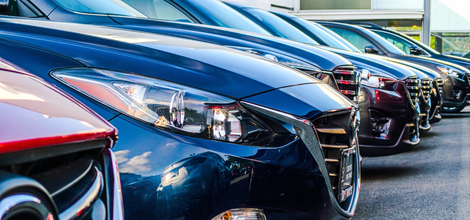 An angled closeup of a line of cars