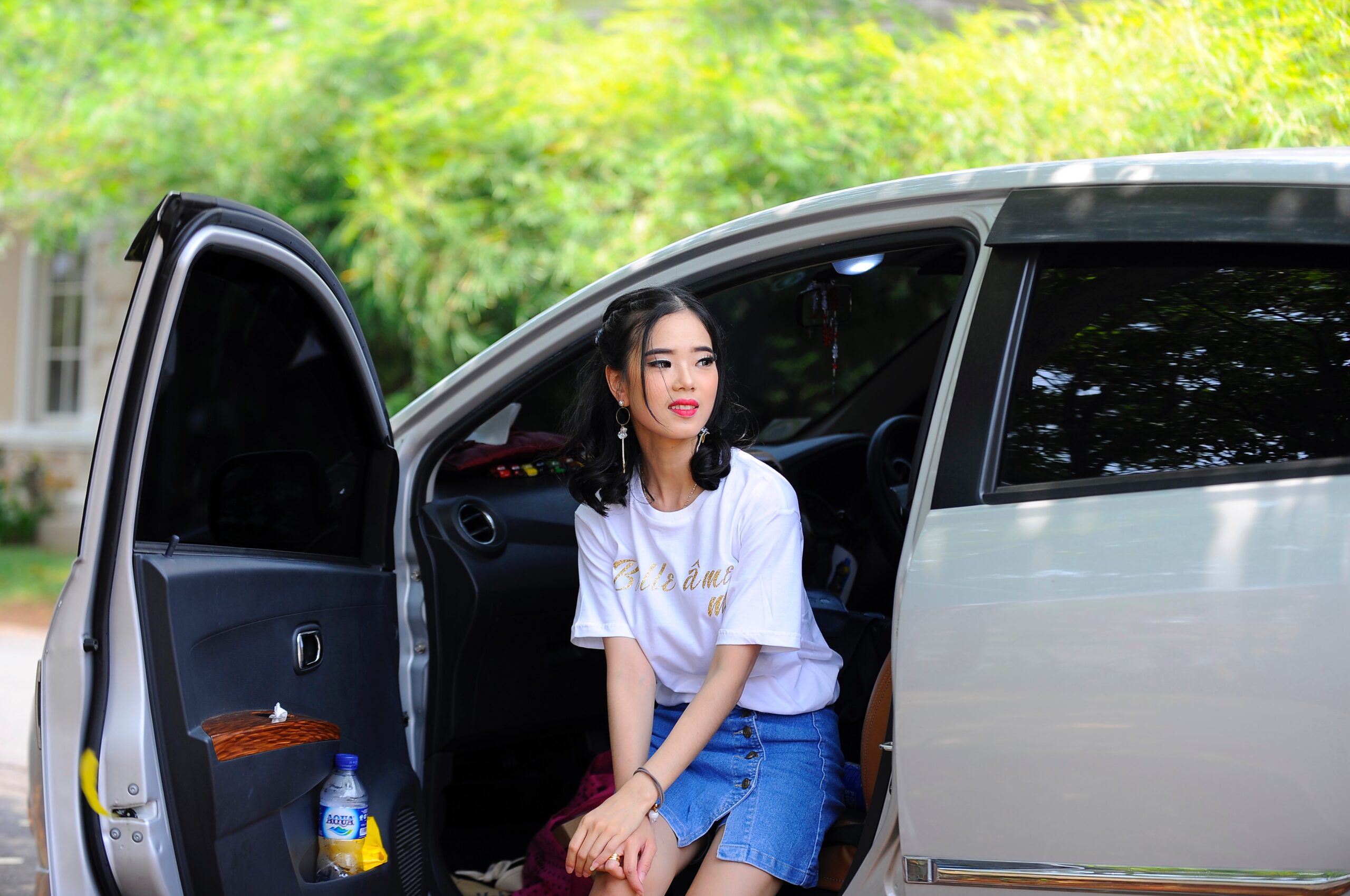 a young woman getting out of a car