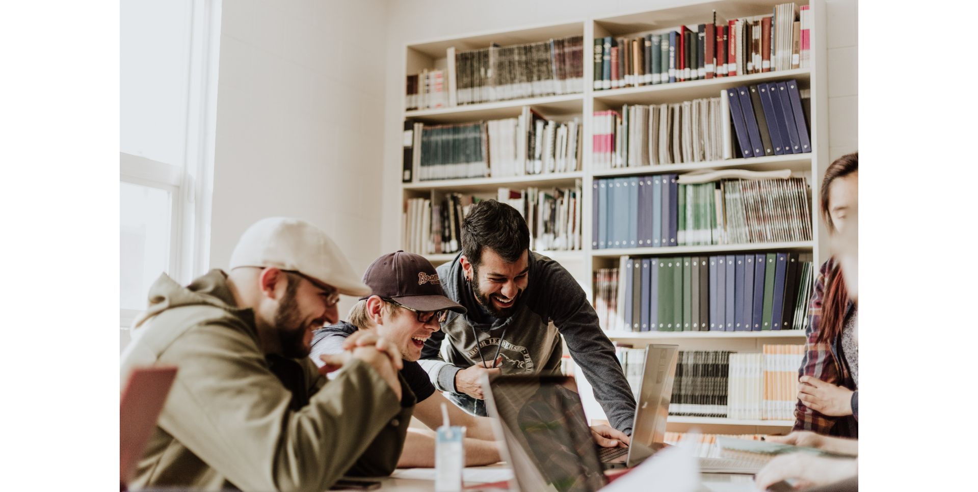 Happy people at work, surrounding a table.