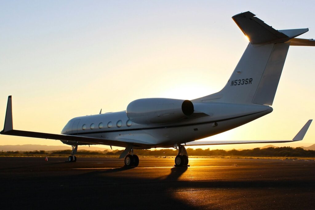 Private jet on the runway during sunset