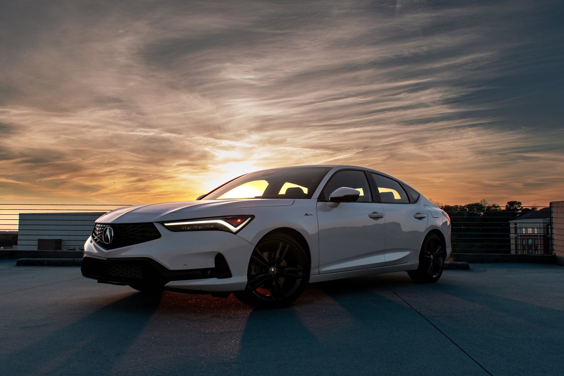 White Acura parked on a lot