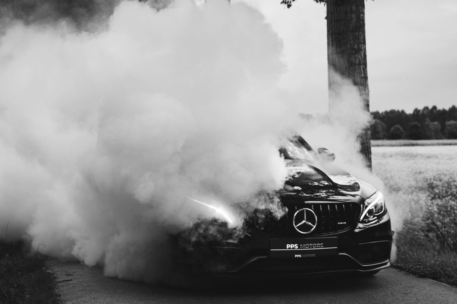 A Mercedes Benz covered in smoke