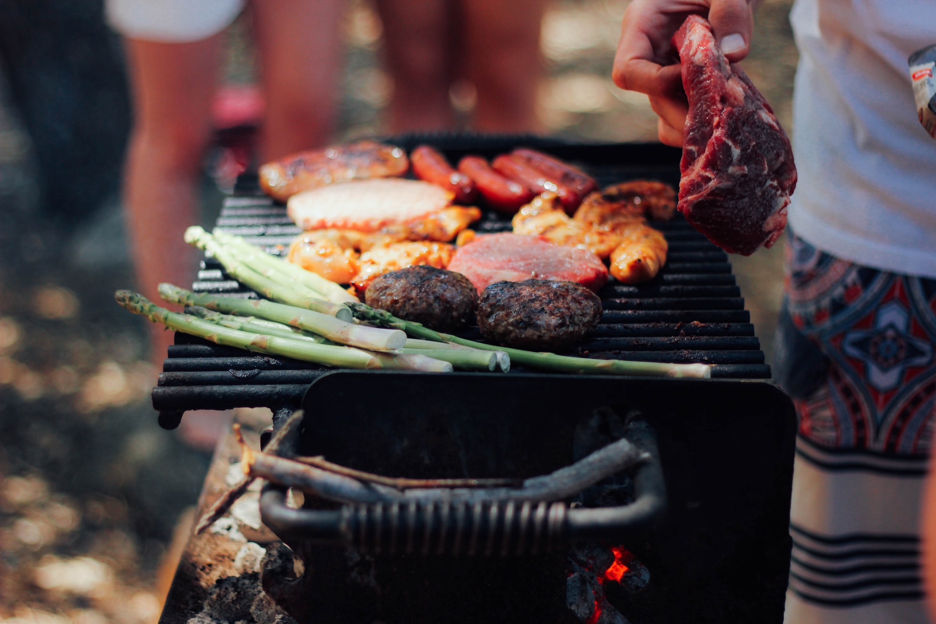 Man cooking on grill.