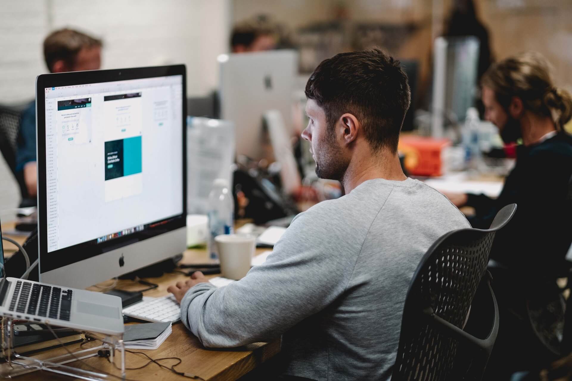 Male office worker in front of a computer